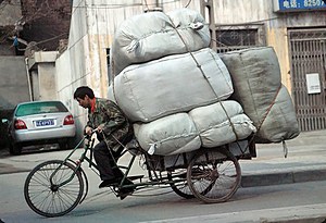 Traditional transport with a modern car behind